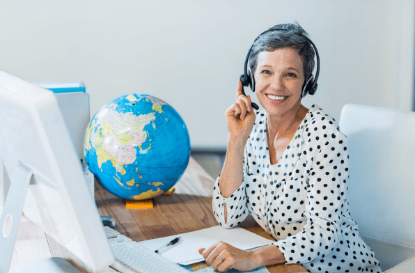 Woman with headset working near a globe.