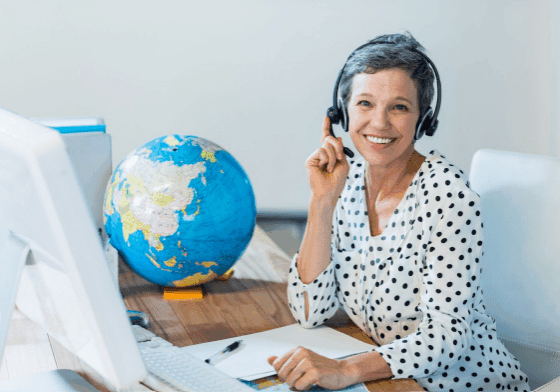 Woman with headset working near a globe.